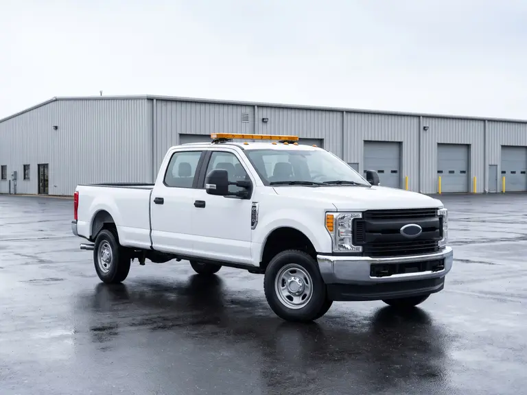 Heavy-duty crew-cab pickup truck in fleet specification on a depot apron