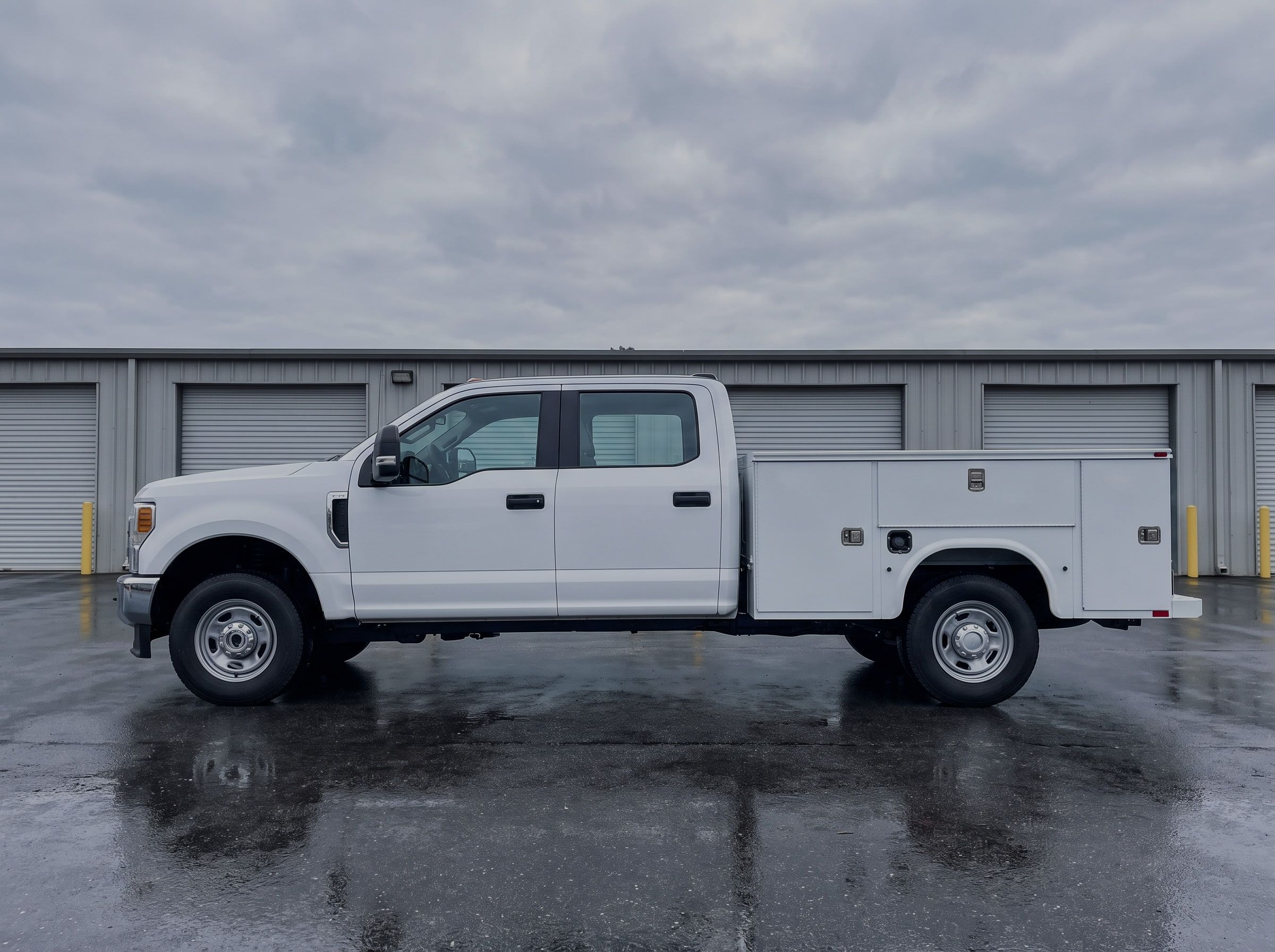 White Ford F350 Super Duty crew cab pickup in GruMac fleet configuration